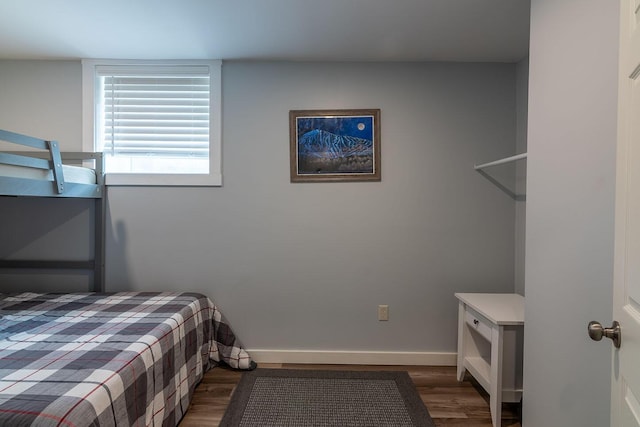 bedroom with wood finished floors and baseboards