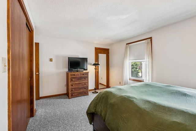55 Lambert St Unit 4, Portland, ME 04103 - carpeted bedroom with a textured ceiling and baseboards