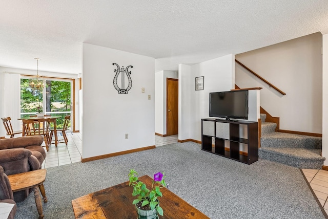 55 Lambert St Unit 4, Portland, ME 04103 - tiled living area with carpet, baseboards, stairs, a chandelier, and a textured ceiling