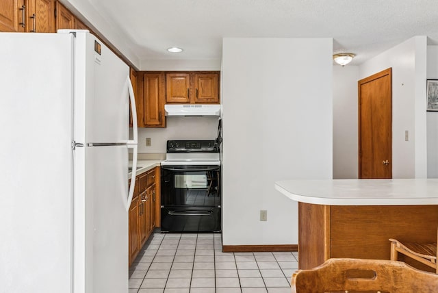 55 Lambert St Unit 4, Portland, ME 04103 - kitchen featuring black range with electric stovetop, under cabinet range hood, freestanding refrigerator, brown cabinetry, and light tile patterned floors