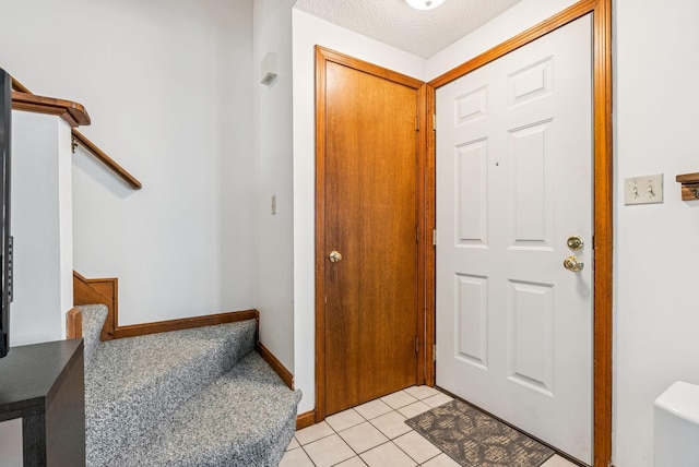 55 Lambert St Unit 4, Portland, ME 04103 - entrance foyer with stairway, light tile patterned flooring, and baseboards