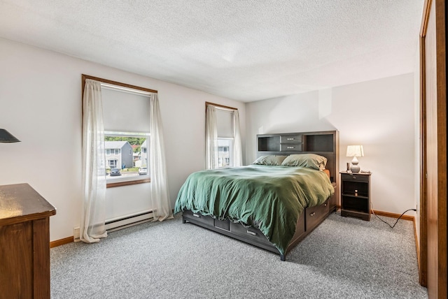 55 Lambert St Unit 4, Portland, ME 04103 - bedroom with carpet, a textured ceiling, baseboard heating, and baseboards