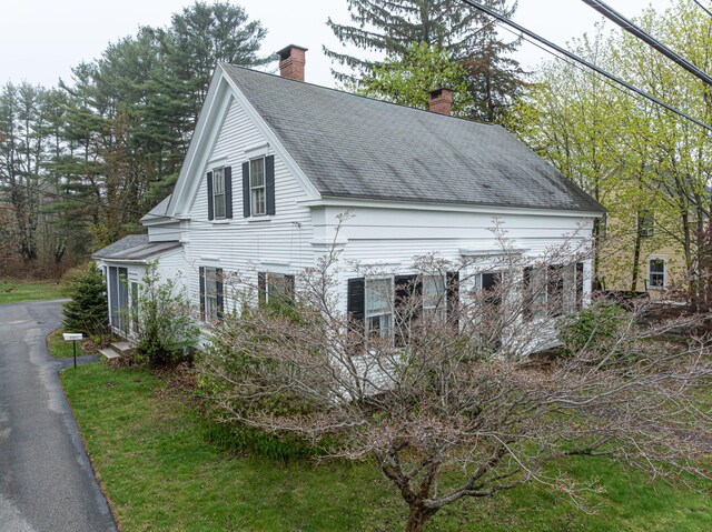 151 Summer St, Kennebunk, ME 04043 - view of home's exterior with a chimney and roof with shingles