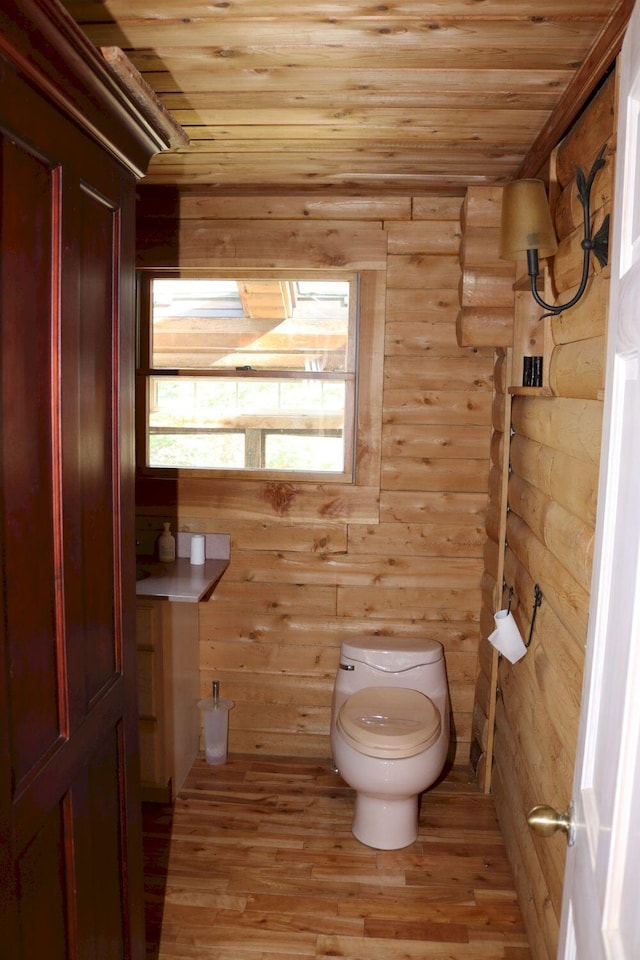 50 Widgeon Rd, Madison, ME 04950 - bathroom with toilet, rustic walls, wood ceiling, and wood finished floors