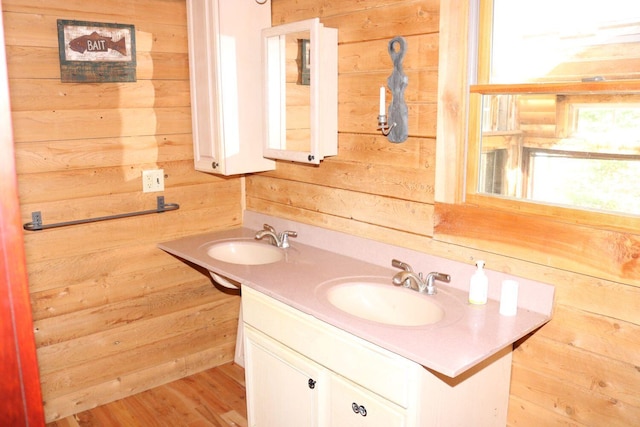 50 Widgeon Rd, Madison, ME 04950 - bathroom with a sink, double vanity, wood walls, and wood finished floors