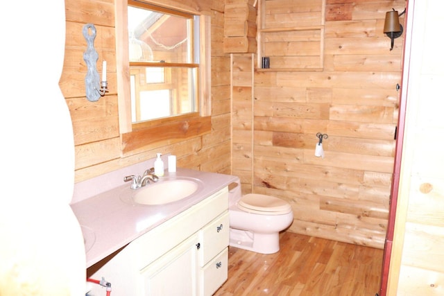 50 Widgeon Rd, Madison, ME 04950 - bathroom with toilet, wood walls, wood finished floors, and vanity