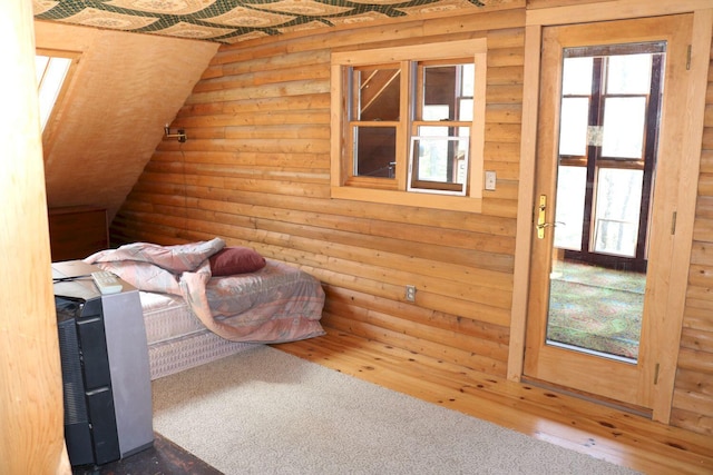 50 Widgeon Rd, Madison, ME 04950 - bedroom with log walls, wood finished floors, and lofted ceiling