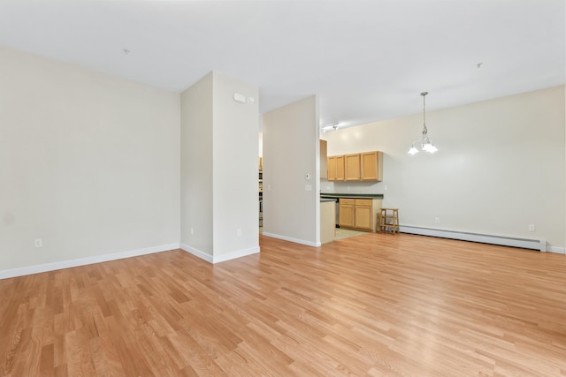 unfurnished living room with a baseboard radiator, a chandelier, light wood-style flooring, and baseboards