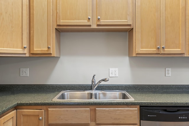 kitchen featuring a sink, stainless steel dishwasher, dark countertops, and light brown cabinetry