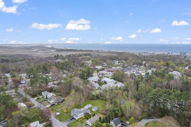 aerial view of property and surrounding area featuring nearby suburban area and a nearby body of water