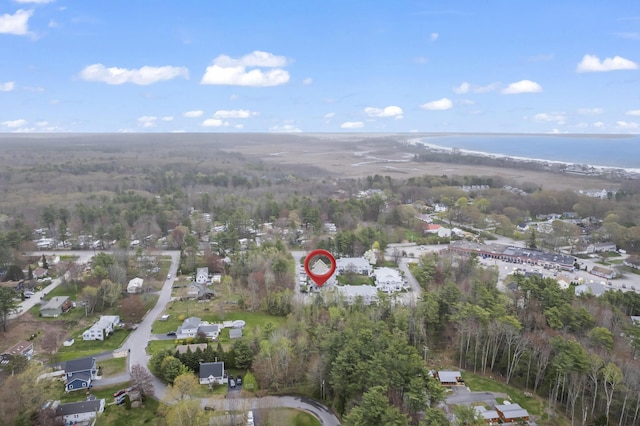 aerial view of property and surrounding area featuring a heavily wooded area