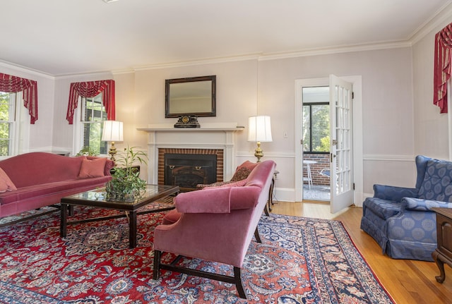 14 Highland St, Portland, ME 04103 - living room featuring healthy amount of natural light, crown molding, wood finished floors, and a fireplace