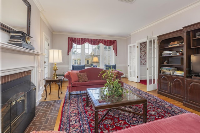 14 Highland St, Portland, ME 04103 - living room with ornamental molding, a fireplace, and french doors