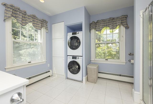14 Highland St, Portland, ME 04103 - laundry area with a baseboard heating unit, stacked washer / dryer, cabinet space, and light tile patterned floors