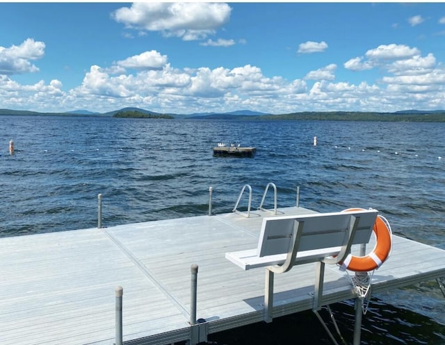 dock area featuring a water and mountain view