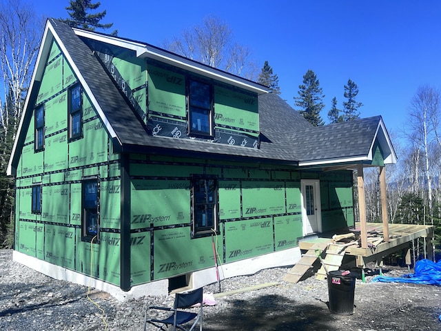 view of home's exterior featuring roof with shingles