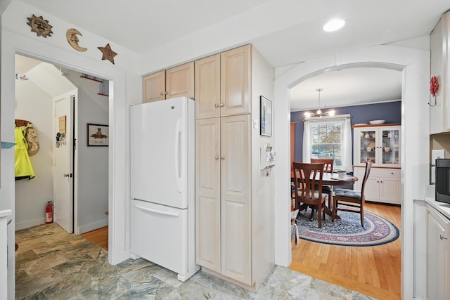 51 Googin St, Lewiston, ME 04240 - kitchen featuring freestanding refrigerator, arched walkways, light brown cabinets, and a chandelier