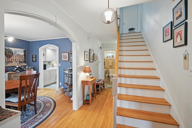 51 Googin St, Lewiston, ME 04240 - staircase featuring wood finished floors, arched walkways, and crown molding