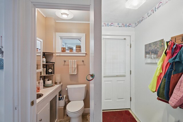 51 Googin St, Lewiston, ME 04240 - bathroom with baseboards, toilet, vanity, and crown molding