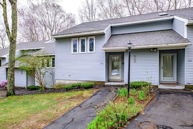 tri-level home with a shingled roof