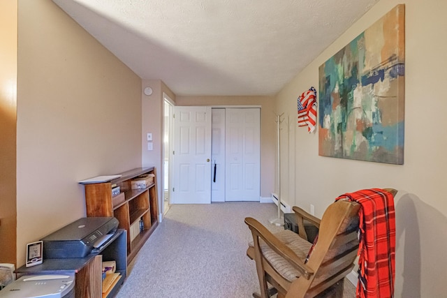 living area with carpet and a baseboard heating unit
