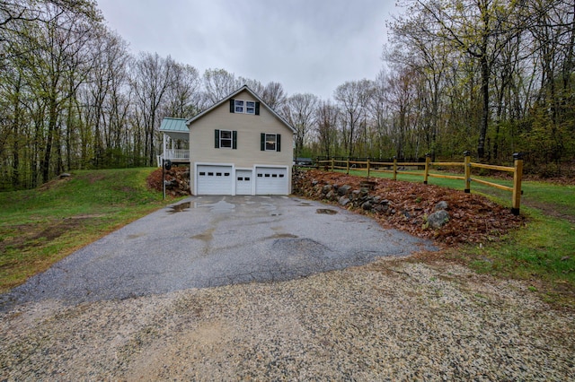 229 Stone Rd, Newfield, ME 04095 - garage featuring driveway, fence, and a forest view