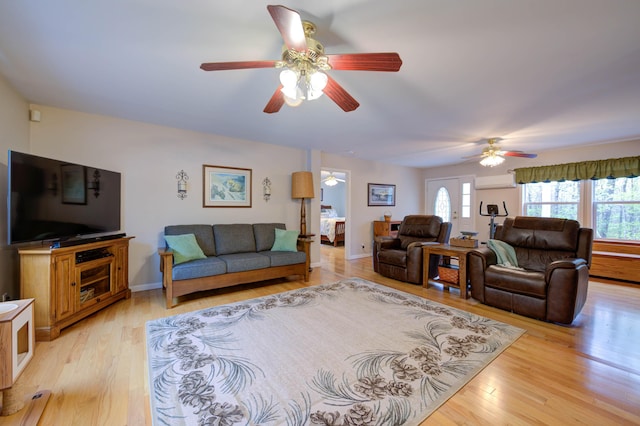 229 Stone Rd, Newfield, ME 04095 - living room with ceiling fan, plenty of natural light, a wall unit AC, and light wood-type flooring