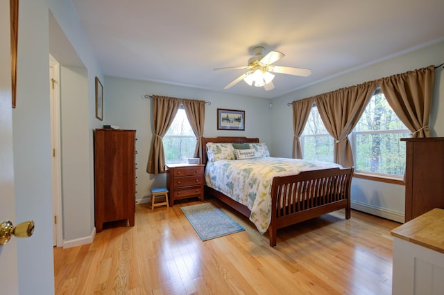 229 Stone Rd, Newfield, ME 04095 - bedroom featuring baseboard heating, light wood finished floors, baseboards, and a ceiling fan