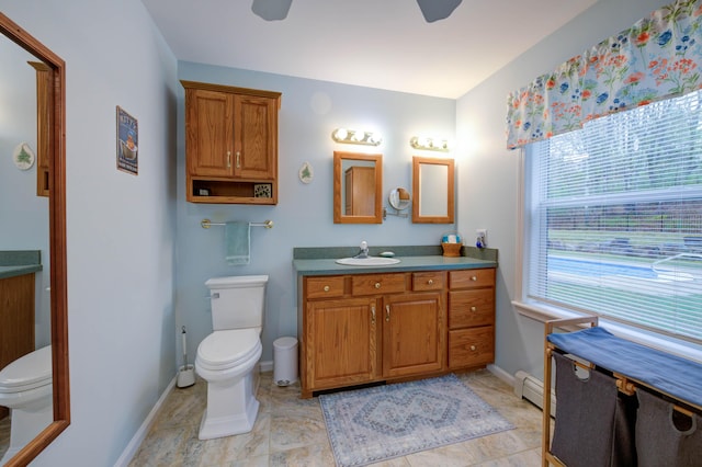 229 Stone Rd, Newfield, ME 04095 - bathroom with toilet, ceiling fan, vanity, and a baseboard radiator