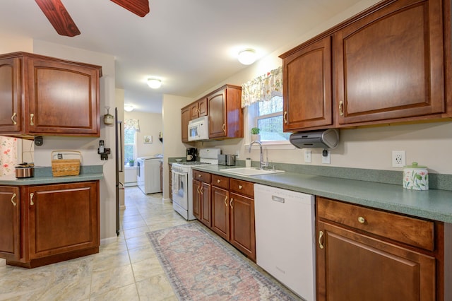 229 Stone Rd, Newfield, ME 04095 - kitchen featuring white appliances, washer / clothes dryer, a sink, light tile patterned floors, and brown cabinets