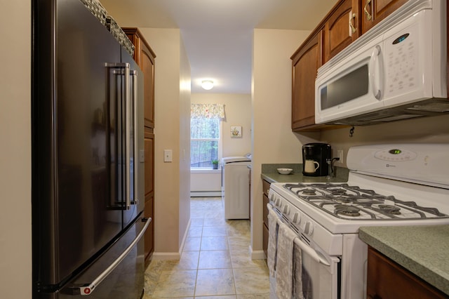 229 Stone Rd, Newfield, ME 04095 - kitchen featuring white appliances, baseboard heating, light tile patterned floors, baseboards, and brown cabinets