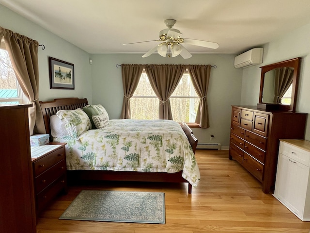 229 Stone Rd, Newfield, ME 04095 - bedroom with a wall mounted AC, baseboard heating, light wood-style flooring, and ceiling fan