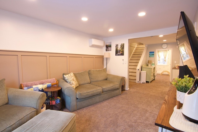 14 Fields Pond Rd, Holden, ME 04429 - living room with light colored carpet, a wall mounted air conditioner, stairs, and a decorative wall
