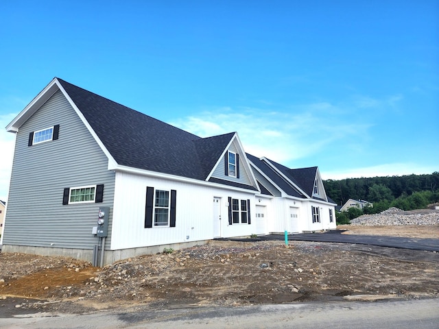 view of front of house with a shingled roof