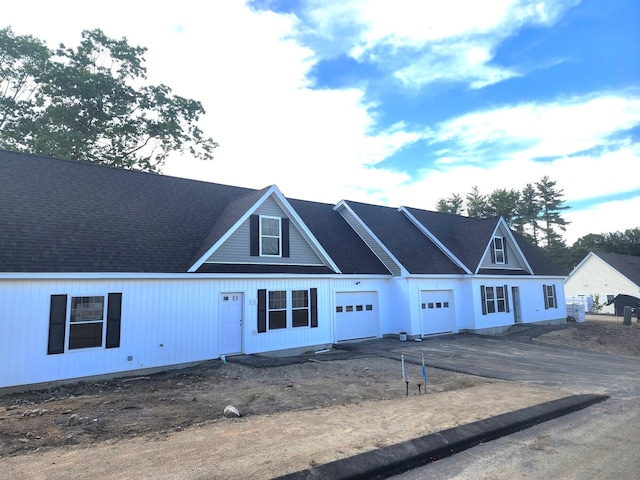view of front of house featuring aphalt driveway and a garage