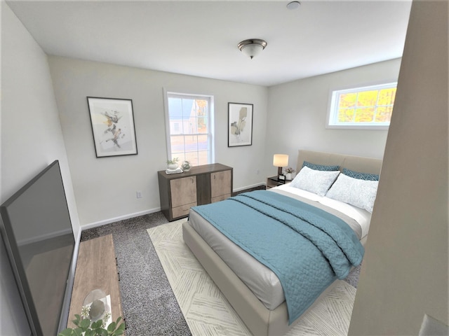 carpeted bedroom with baseboards and multiple windows