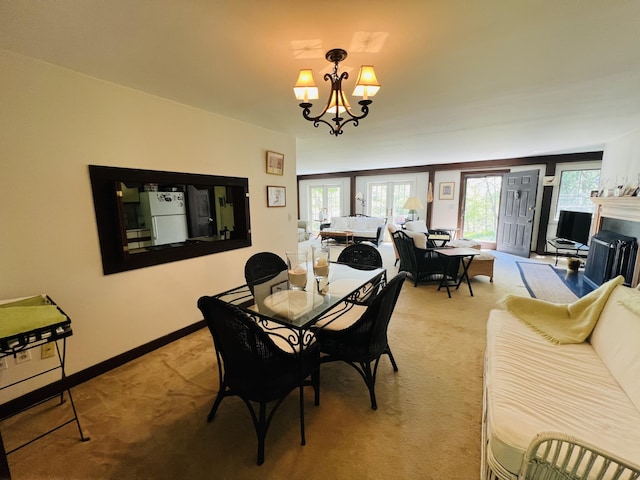329 Salt Pond Rd, Blue Hill, ME 04614 - dining area featuring light carpet, a chandelier, and baseboards