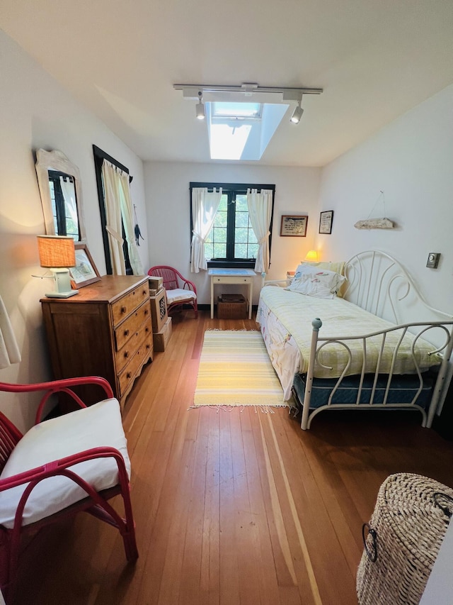 329 Salt Pond Rd, Blue Hill, ME 04614 - bedroom with rail lighting and hardwood / wood-style flooring