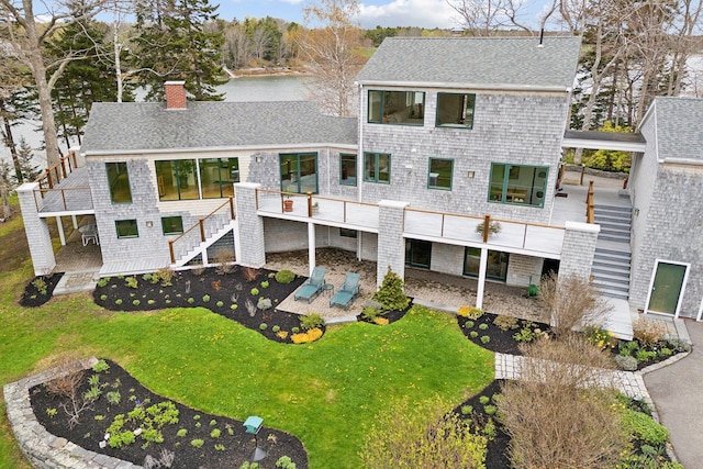 388 High Head Rd, Harpswell, ME 04079 - rear view of property with a chimney, stairway, a patio area, roof with shingles, and a lawn
