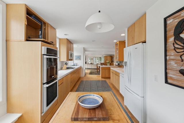 388 High Head Rd, Harpswell, ME 04079 - kitchen with white appliances, modern cabinets, light countertops, light wood-style flooring, and decorative light fixtures