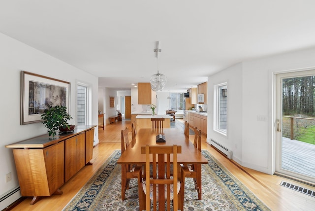 388 High Head Rd, Harpswell, ME 04079 - dining space with a baseboard radiator, light wood-style flooring, and baseboards