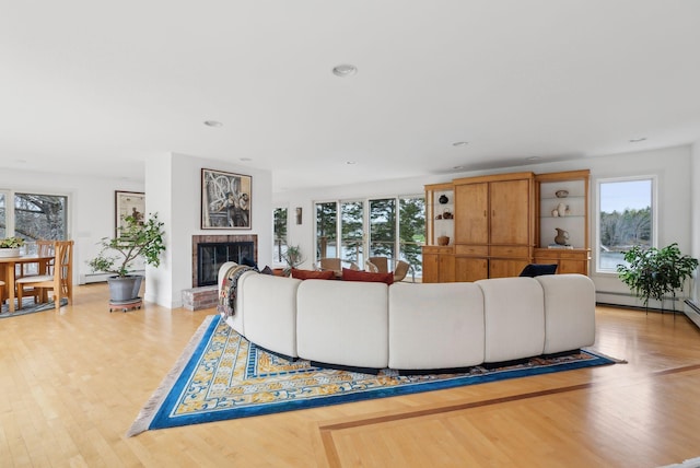 388 High Head Rd, Harpswell, ME 04079 - living area with wood finished floors, healthy amount of natural light, a brick fireplace, and recessed lighting