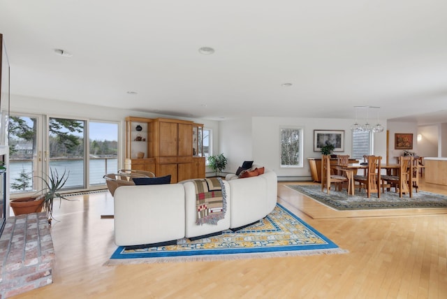 388 High Head Rd, Harpswell, ME 04079 - living room featuring wood finished floors, a chandelier, and a water view