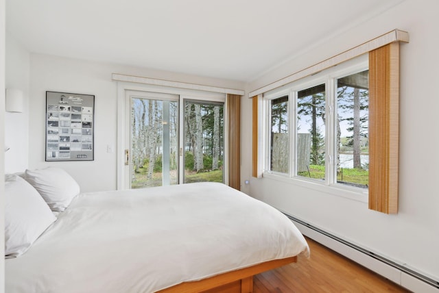 388 High Head Rd, Harpswell, ME 04079 - bedroom featuring a baseboard heating unit, access to exterior, and wood finished floors
