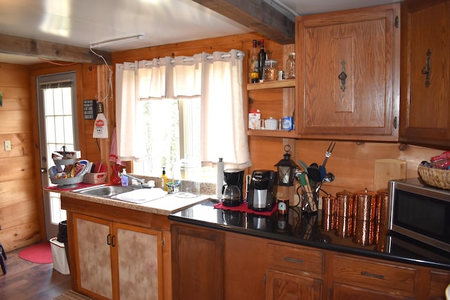 1352 Main Rd, Carroll Plt, ME 04487 - kitchen featuring stainless steel microwave, brown cabinets, wood walls, and wood finished floors