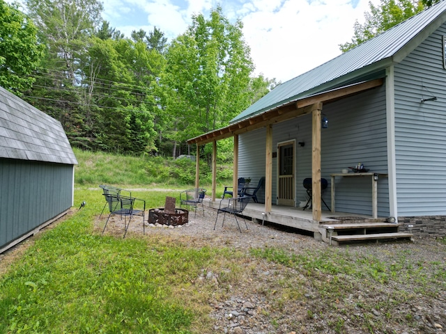 1352 Main Rd, Carroll Plt, ME 04487 - view of yard with an outdoor fire pit, a deck, and an outdoor structure