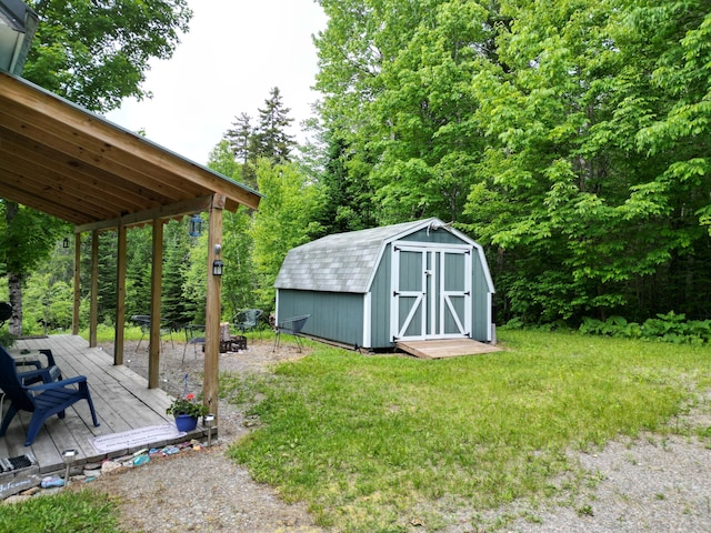 1352 Main Rd, Carroll Plt, ME 04487 - view of grassy yard with a fire pit, a storage unit, and a deck
