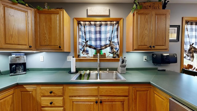 kitchen with a sink and brown cabinetry