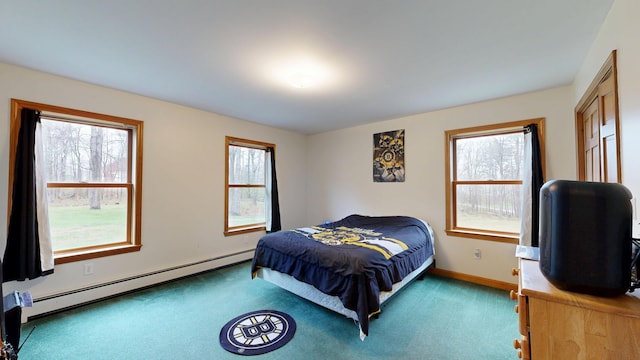 bedroom featuring a baseboard heating unit, carpet floors, and baseboards