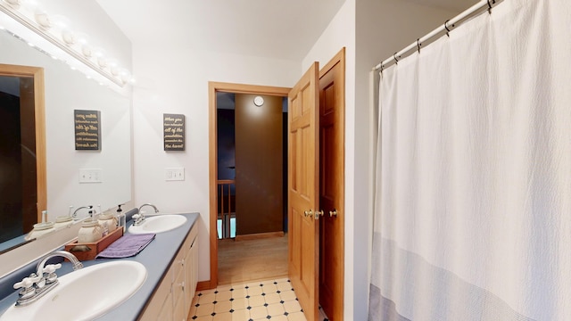 bathroom with tile patterned floors and double vanity